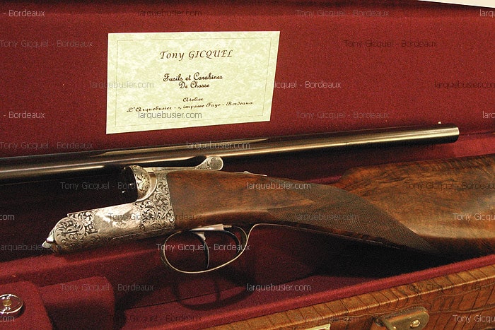 Fusil de chasse gravé de Tony Gicquel, désassemblé dans son étui en velours rouge. Label: 'Tony GICQUEL, Fusils et Carabines De Chasse, Bordeaux'.